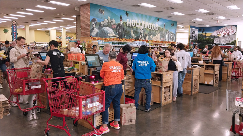 Customers line up with groceries at the checkout lanes in a Trader Joe's