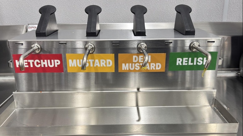 Costco's hot dog topping dispenser with the addition of deli mustard