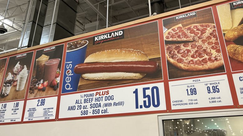 A closeup of the Costco menu board with drinks, pizza, and hot dog.