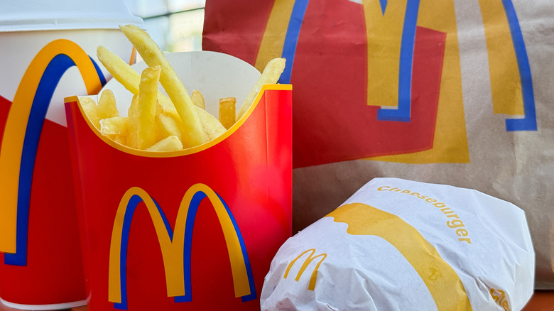 A closeup of a McDonald's drink, fried, burger, and bag