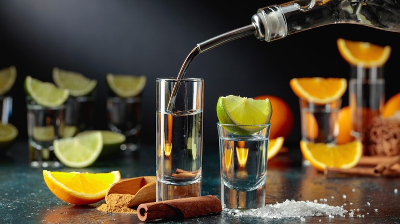 Tequila being poured into a shot glass.