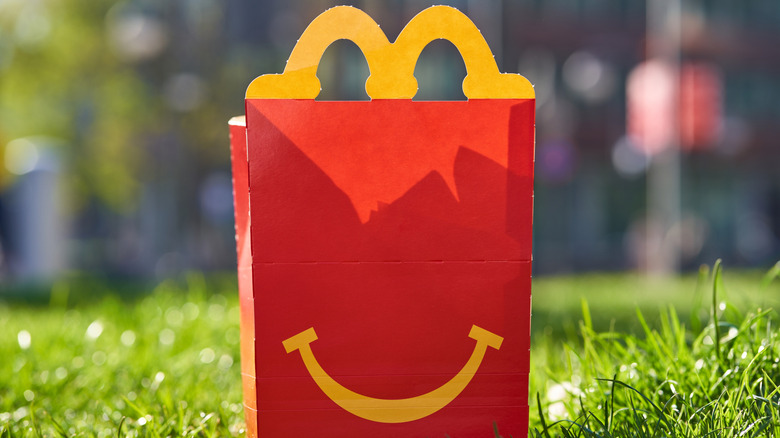 Red McDonald's Happy Meal box sitting in grass