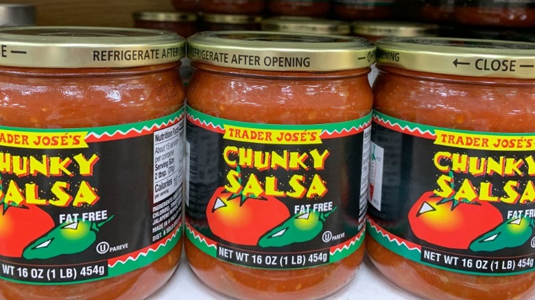 Cans of Trader Joe's chunky salsa on a store shelf