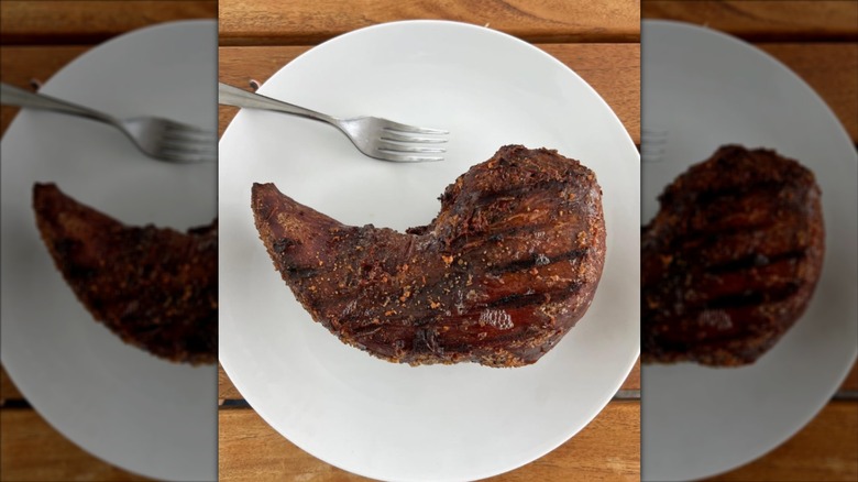 Smoked and cured bison tongue sitting on a plate.