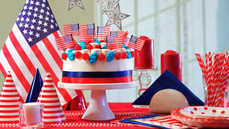 A July 4th spread with red, white, and blue cake on cake stand