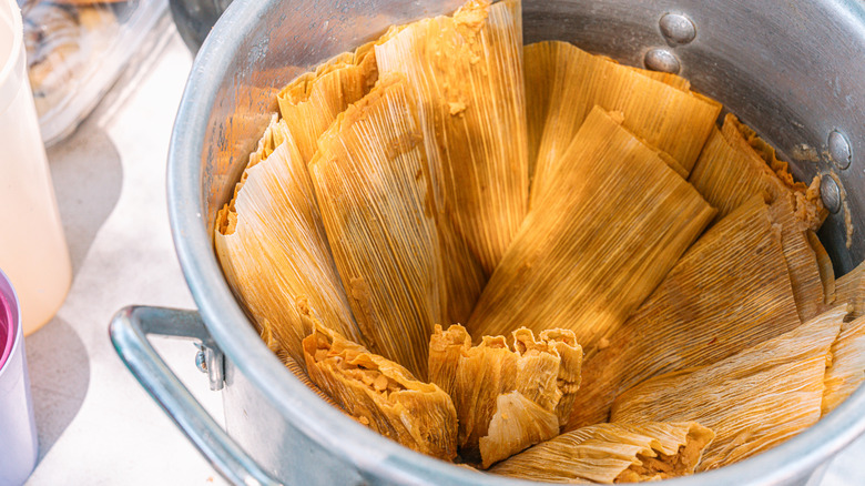 Steamed tamales in a pot on a table
