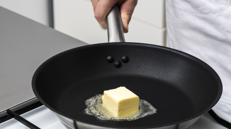 A pat of butter melting in a pan