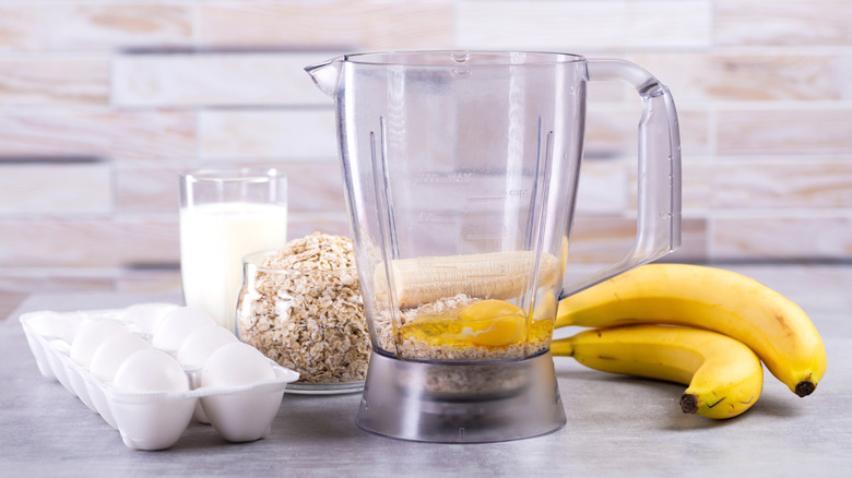 Blender with eggs, oats, milk, and fresh banana