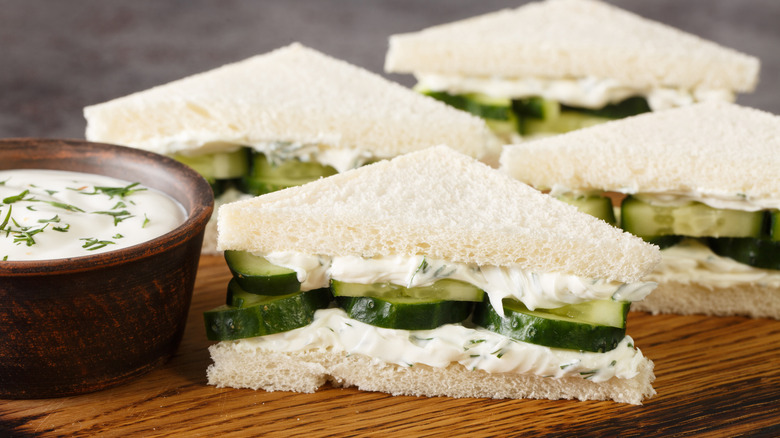 Four cucumber sandwiches with dip