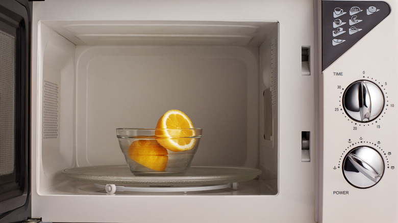 halved lemon in bowl in the microwave