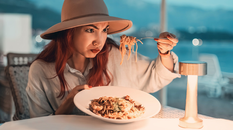 Tourist examining a restaurant meal