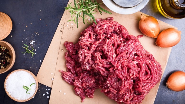 The raw ingredients for meatballs include ground meat, onions, and seasonings