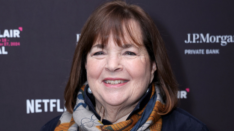Smiling Ina Garten standing in front of a black background