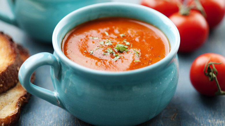tomato soup in a blue soup cup