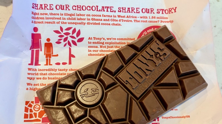 A Tony's Chocolonely milk chocolate bar and inside wrapper