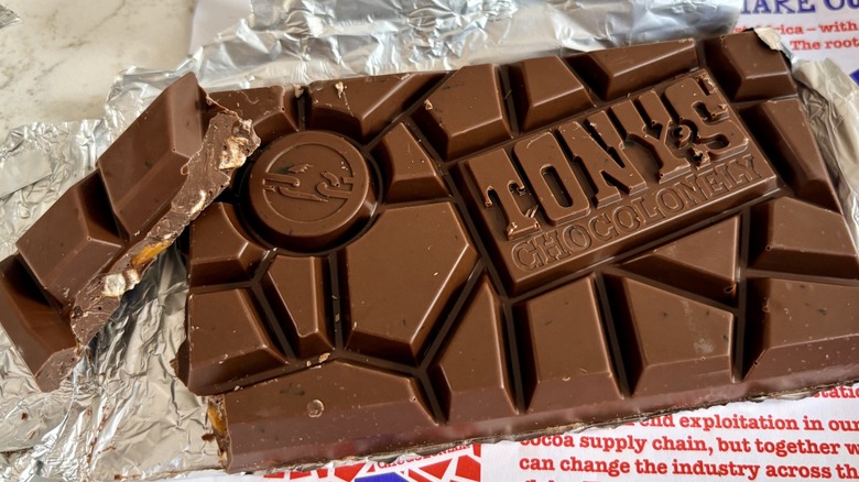 A chunk of Tony's Chocolonely milk chocolate pretzel toffee bar