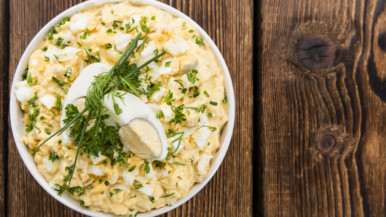 egg salad in bowl on wooden table
