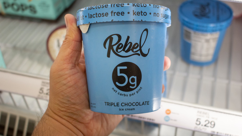 A hand holding a pint of Rebel Ice cream
