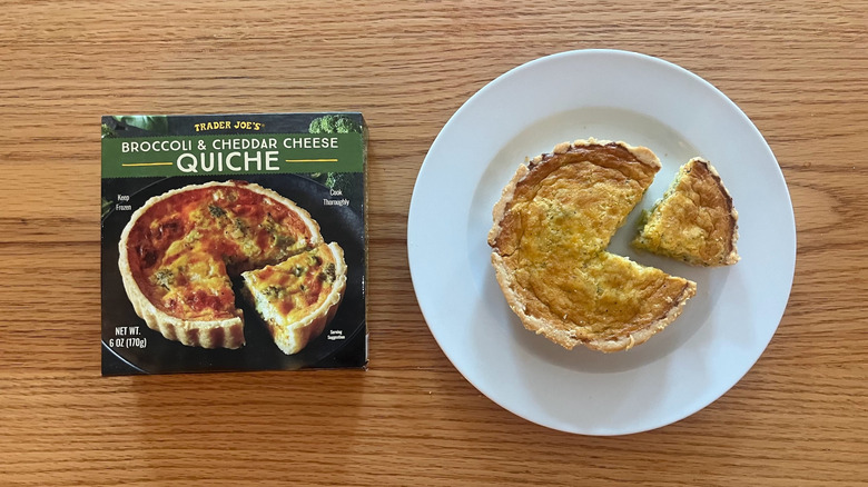 Trader Joe's Broccoli and Cheddar Cheese Quiche on a plate with a slice cut out