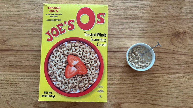 Joe's Os box next to a bowl of the cereal with a spoon