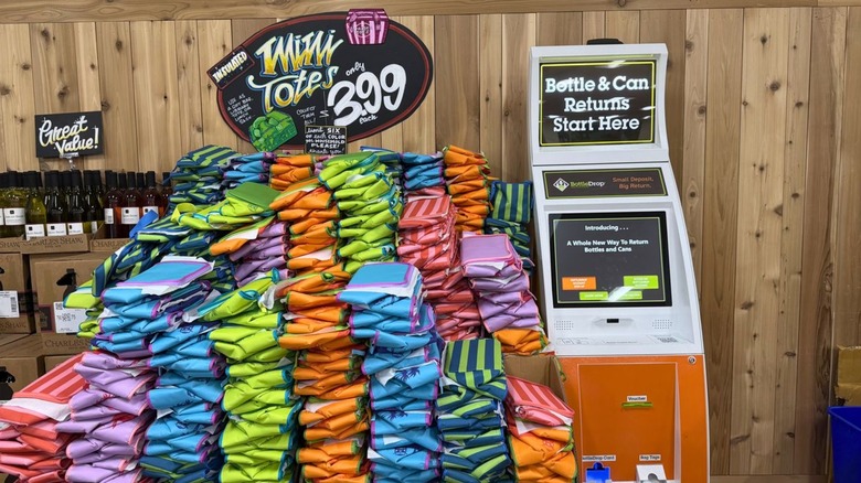 A mound of Trader Joe's insulated mini totes next to bottle and can machine