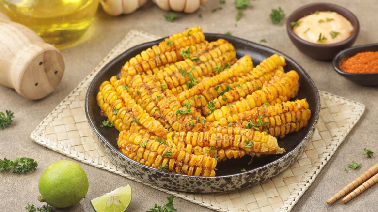 Corn ribs alongsides mayo, chile pepper, and lime