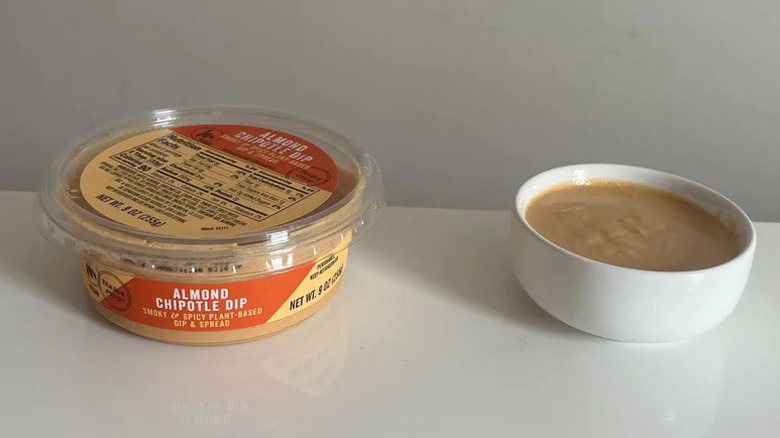 Container of Almond Chipotle Dip with bowl next to it filled with dip.