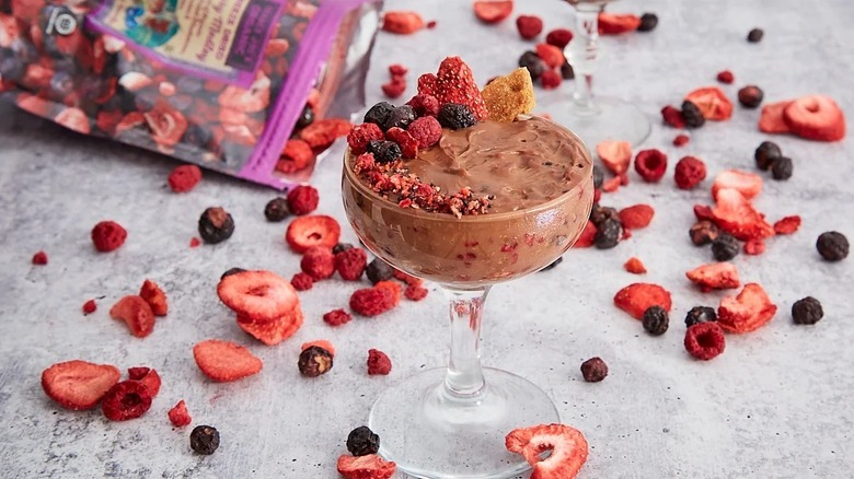 Trader Joe's freeze-dried berries on top of a glass of something brown and creamy