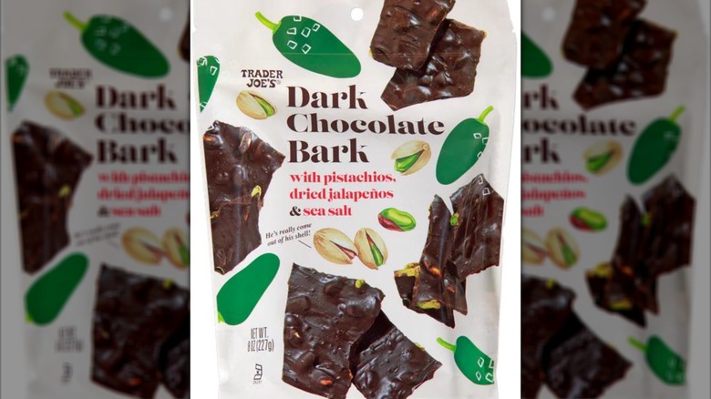 An unopened bag of the Trader Joe's Dark Chocolate Bark with Pistachios, Dried Jalapeños & Sea Salt on a white background.