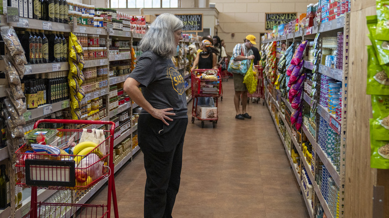 A customer shops for canned items at Trader Joe's