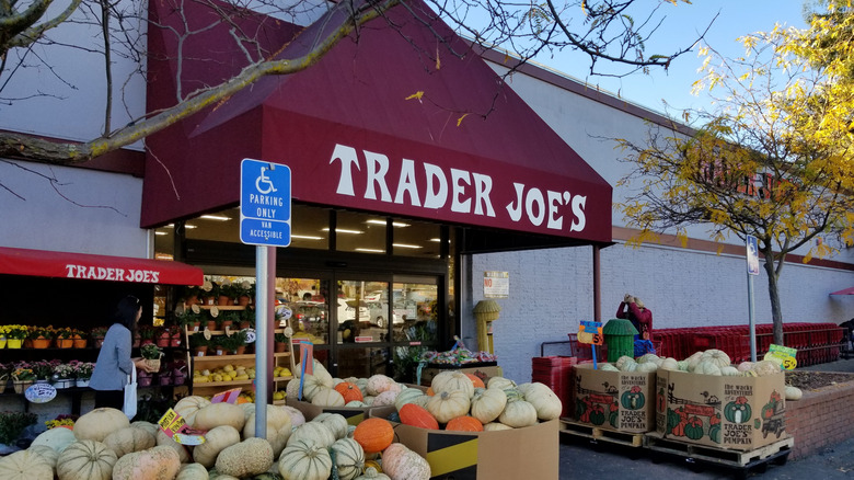 The entrance to a Trader Joe's with pumpkins outside.