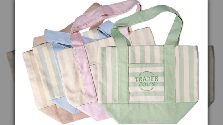 Trader Joe's mini tote bags in pastel green, pink, blue, and brown on a white background.