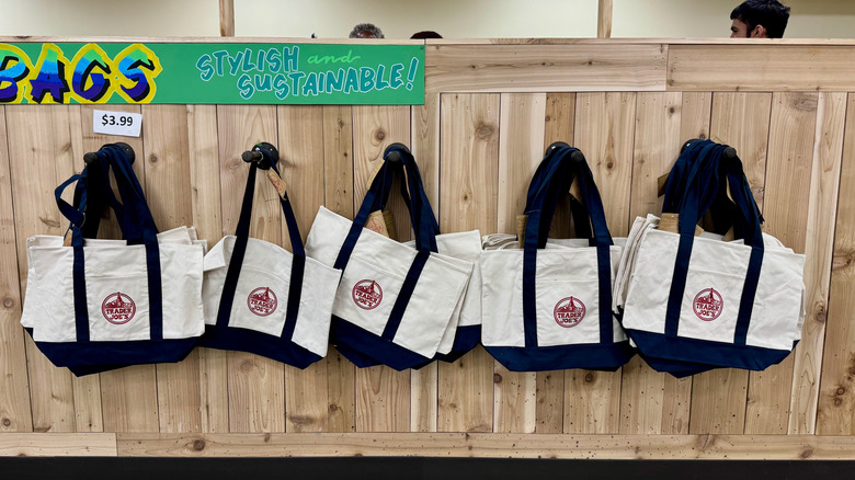 A display of reusable grocery totes at trader joe's
