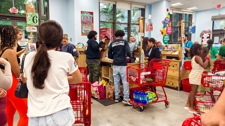 A crowd of customers at Trader Joe's checking out.