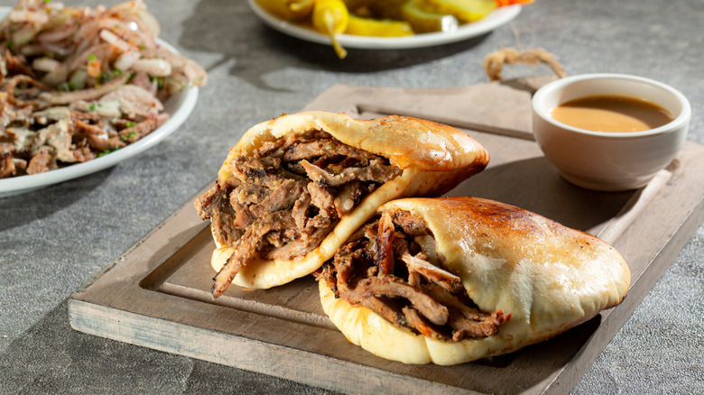 Shaved lamb stuffed inside round pita breads