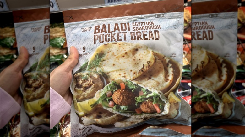 Hand holding bag of Trader Joe's Baladi Egyptian Sourdough Bread