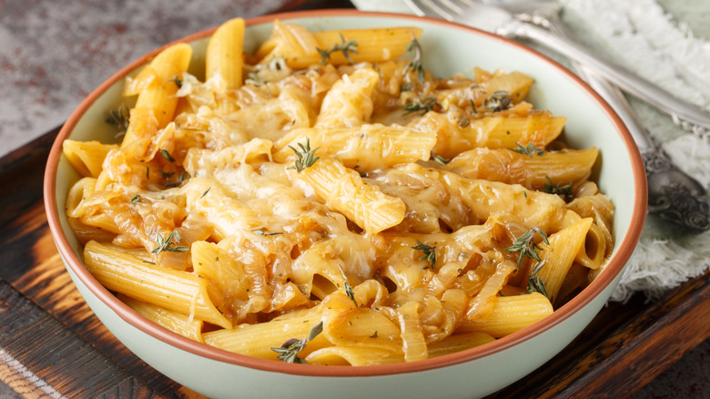 French onion penne pasta with caramelized onions, fresh thyme, and melted cheese