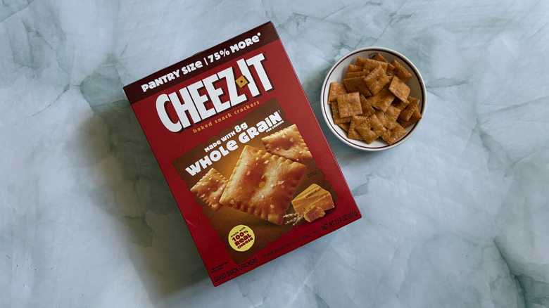 Box of Cheez-It Whole Grain Snack Crackers next to bowl of the Cheez-Its