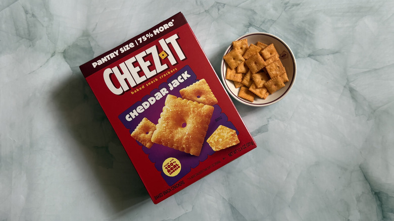 Box of Cheez-It Cheddar Jack Snack Crackers next to bowl of the Cheez-Its