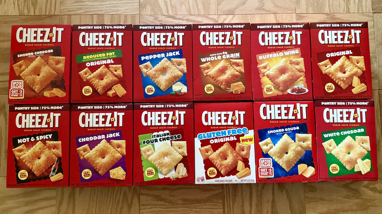 several boxes of different Cheez-It flavors on wooden surface, including original and white cheddar