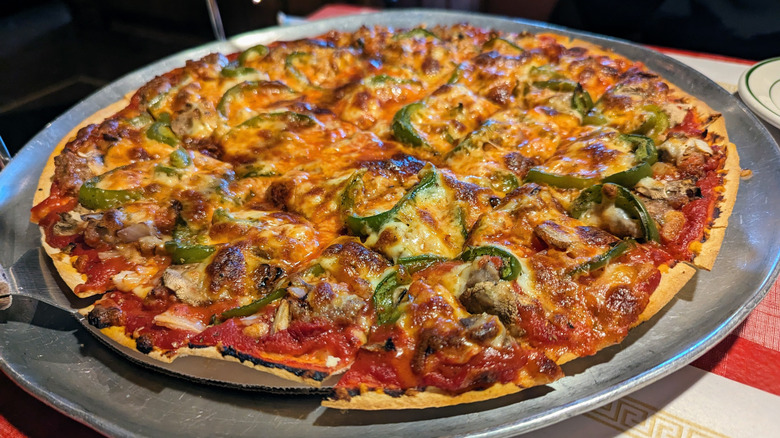 tavern style pizza on metal tray