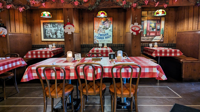 interior of pizzeria tables with red checkered tablecloth