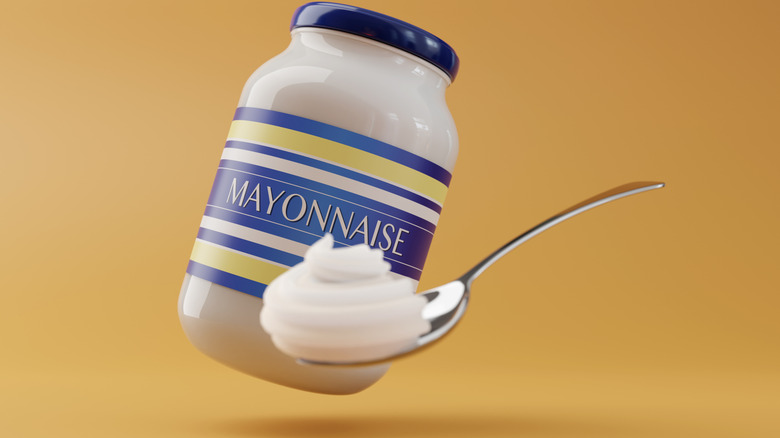 A jar of mayonnaise with a heaping teaspoon of mayo