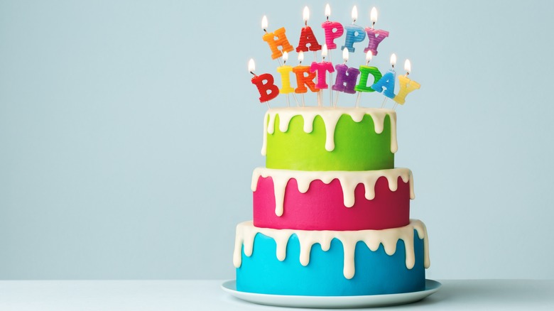 multi-colored three-tiered birthday cake