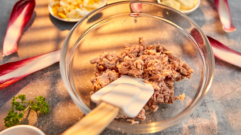 canned tuna in glass bowl with spatula