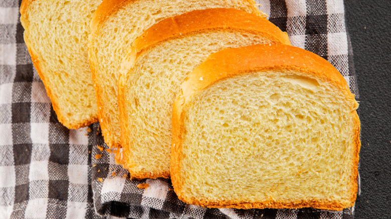 Sliced brioche bread on black and white checkered cloth
