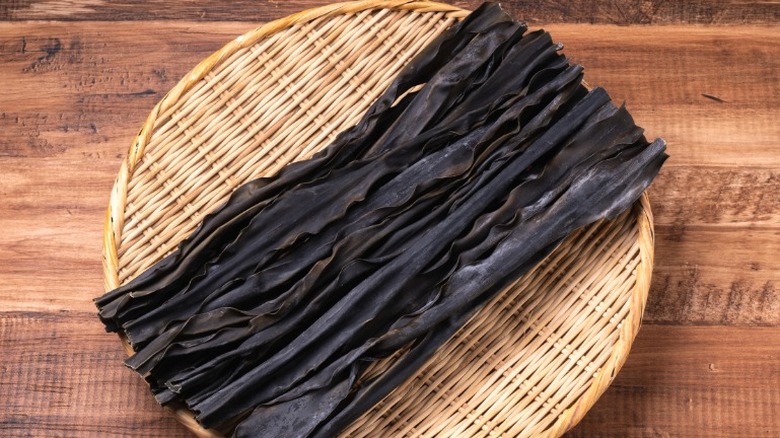 Kombu, or edible kelp, on a wicker plate.