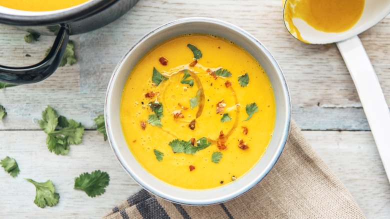 An overhead view of a bowl of butternut squash soup.
