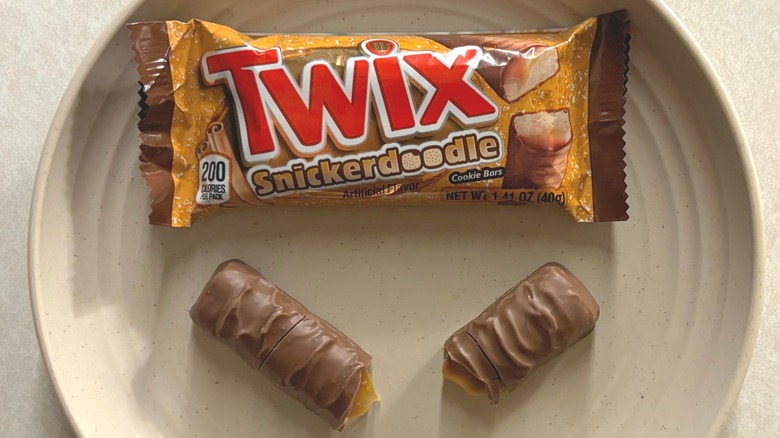 Twix Snickerdoodle Cookie Bar on a plate alongside its wrapper