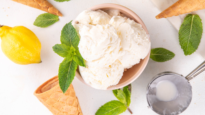 Lemon sorbet in a bowl with ice cream cones and mint